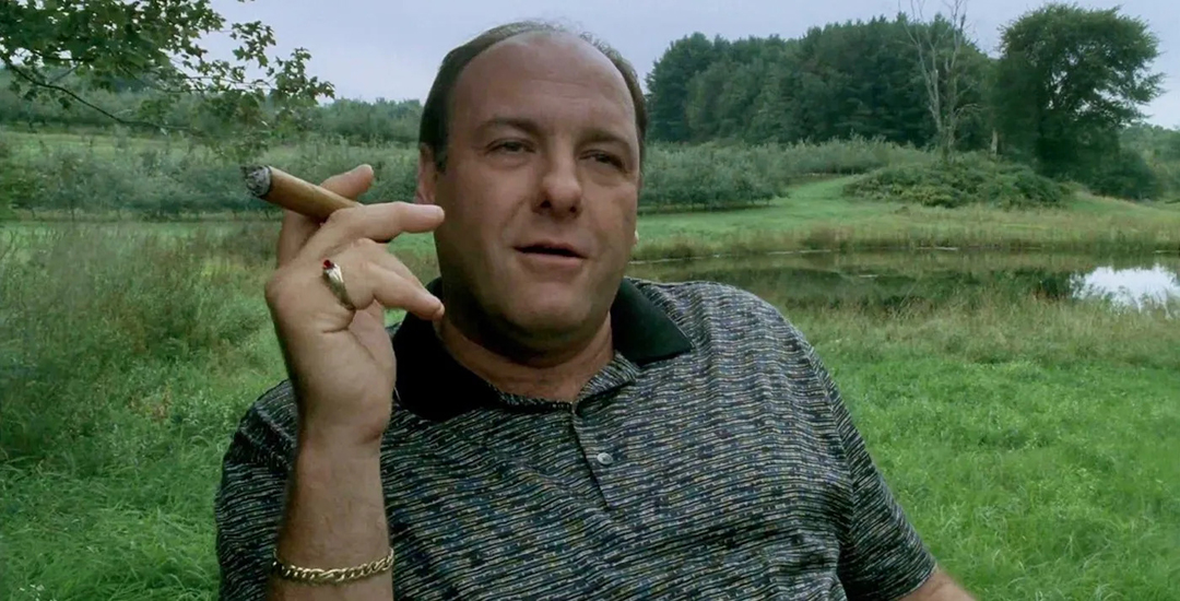 Tony Soprano smoking a cigar outdoors