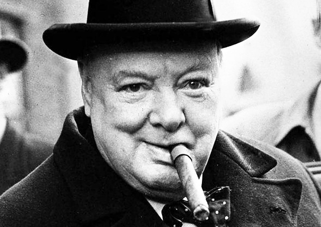 Winston Churchill puffing cigar in his mouth