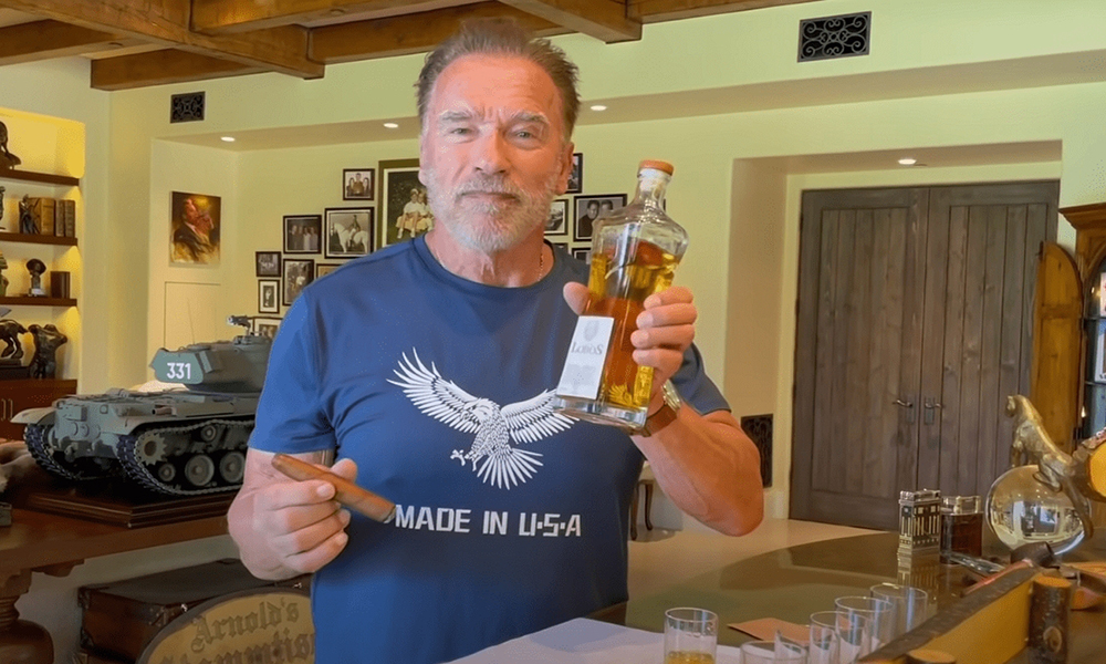 Arnold Schwarzenegger drenching his cigar with tequila