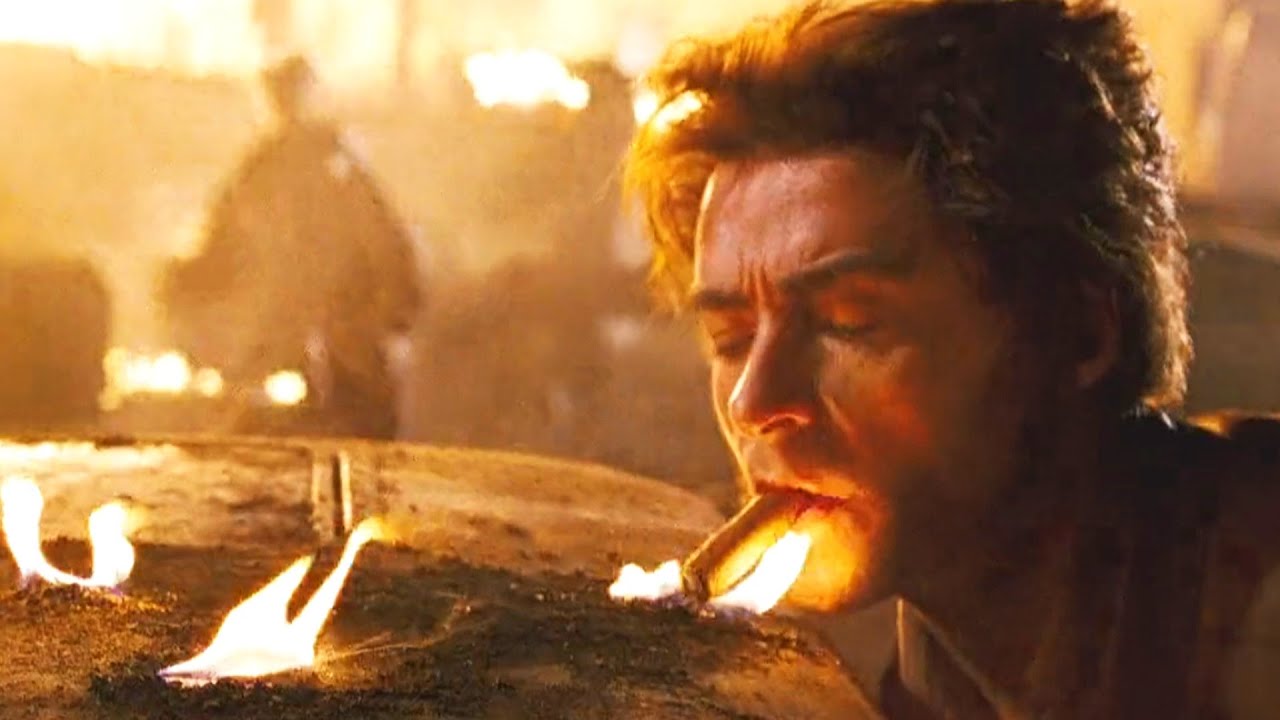 Wolverine lighting cigar from a burnt car