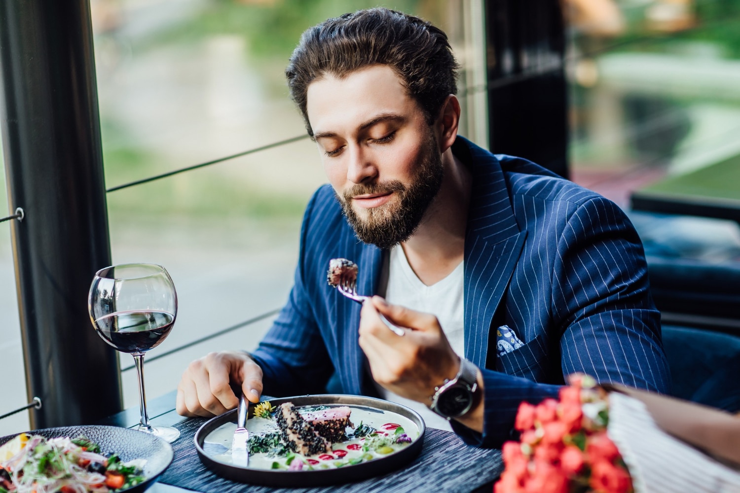 Man eating a salad in a restaurant