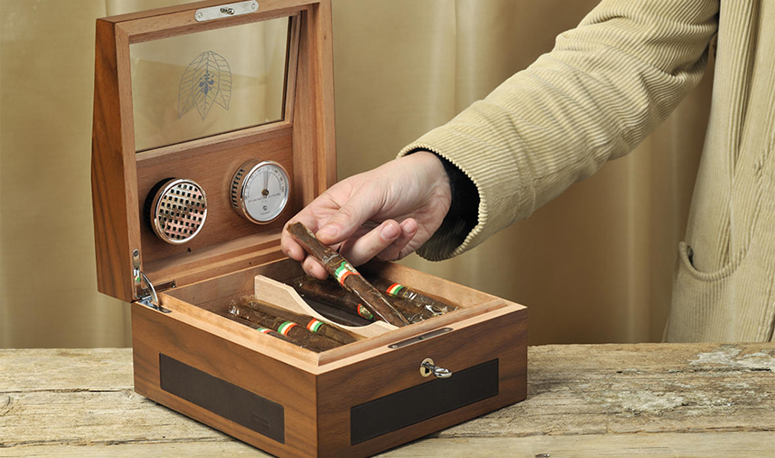 Picking cigars from a humidor